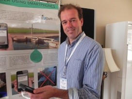 Peter-Jules van Overloop displaying his mobile phone app for canal management