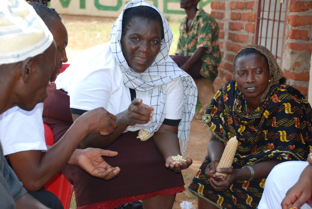 Women can also be decision makers. Here a female agricultural extension worker (center) talks to women and men farmers about drought-tolerant maize.