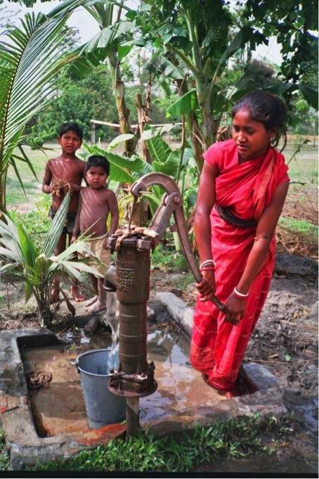 A woman beneficiary of a hand pump in 1995.