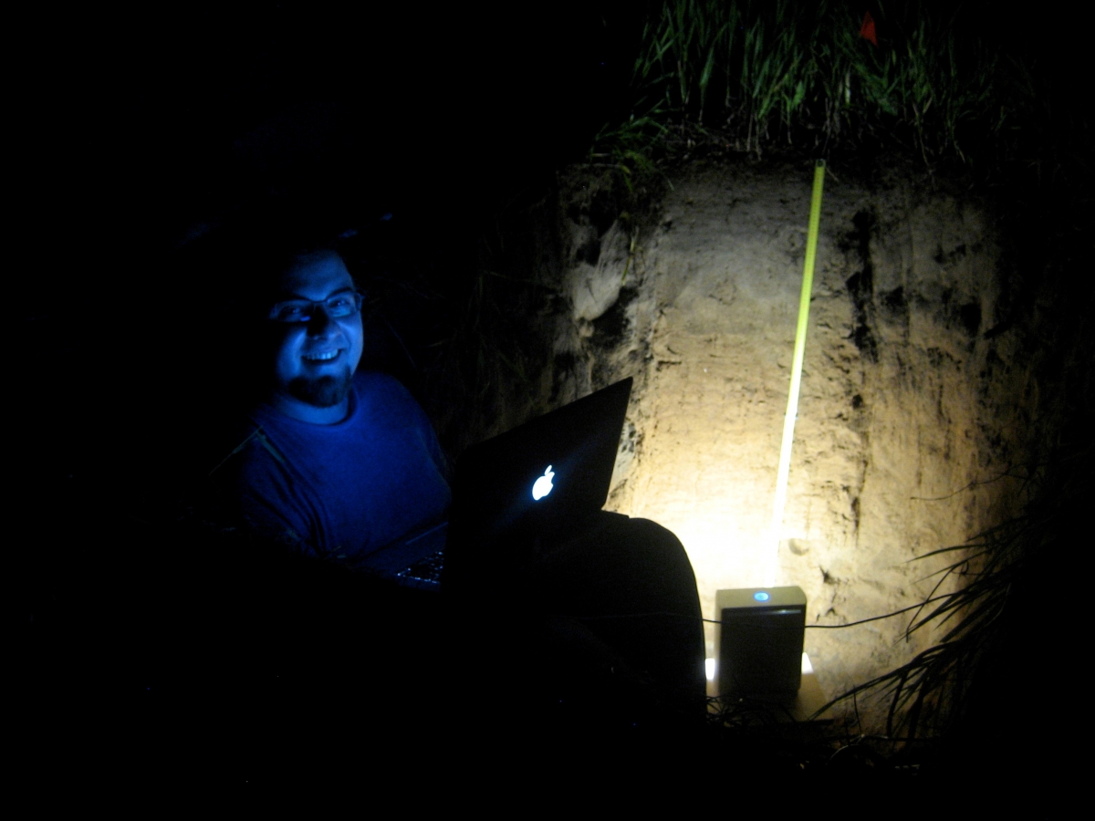 Daniel Hirmas, a professor at University of Kansas, uses the MLT scanner at night in a soil pit.  
