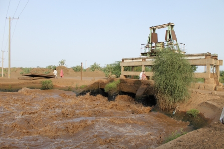 Men and women near a dam in the Gezira Irrigation scheme, Sudan.