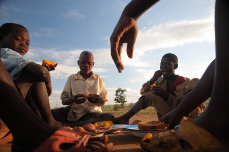 Mozambique eating sweet potato