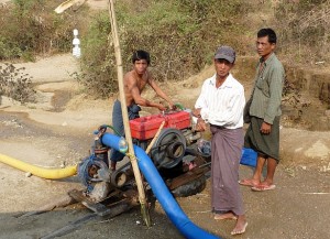 Villagers pumping from a sand dam to their village pond