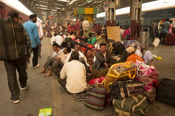 Migrants. Rameshwar Garode and 40 neighbors wait for the train home at New Delhi station. Because of water shortages during the dry periods, migrants like Rameshwar leave their farms on the agricultural off-season to work in cities and only return when conditions are more favorable. Photo: Ruhani Kaur
