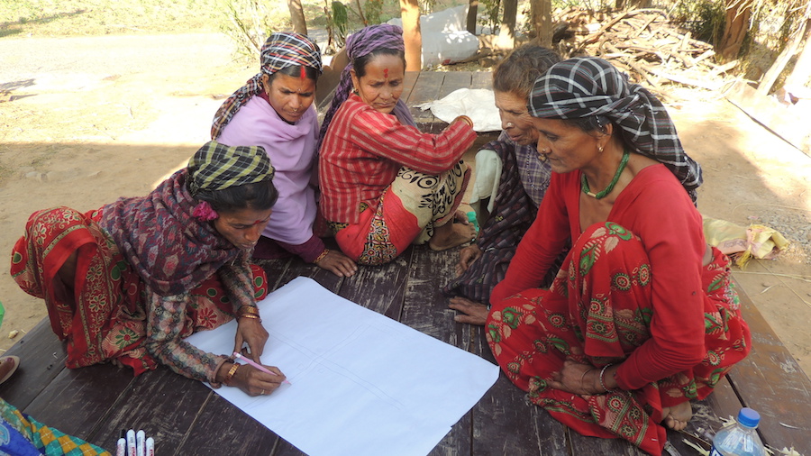 An illiterate woman helps draw a resource map of the village of Tiltali in Doti, Far Western Nepal.