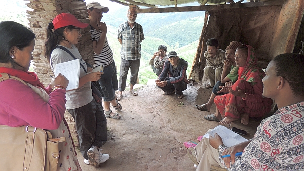 IWMI researchers Ambika Khadka and Romulus Okwany meet with members of the local watershed committee to discuss baseline flows and historical uses
