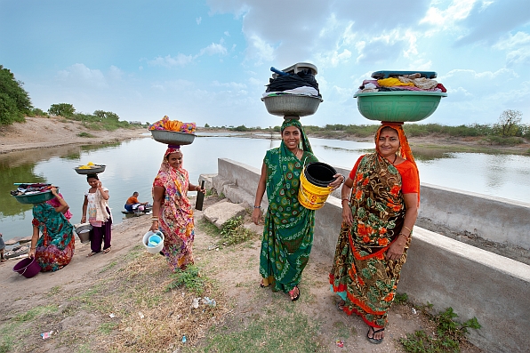 Women collect and use water for domestic use in India