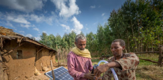 Sewagegn, a local smallholder farmer, and Gebeyaw, a data collector, set up Sewagegn's solar powered pump to irrigate her backyard garden in Danghesta, Amhara region of Ethiopia. Photo by Mulugeta AyeneWLE.