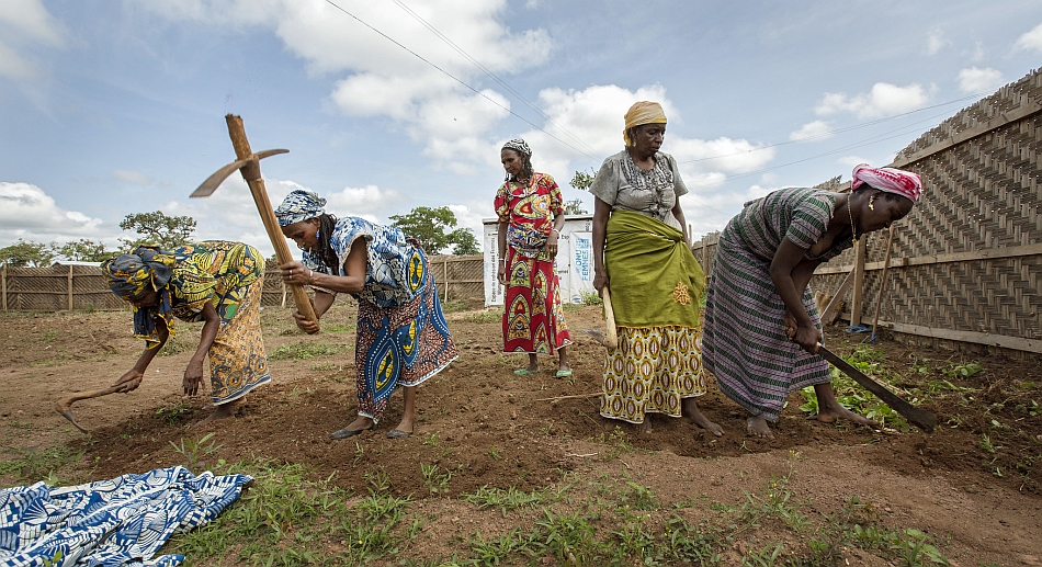 Women break ground on a garden plot located within the UN Women Safe Centre section of a refugee camp in Africa