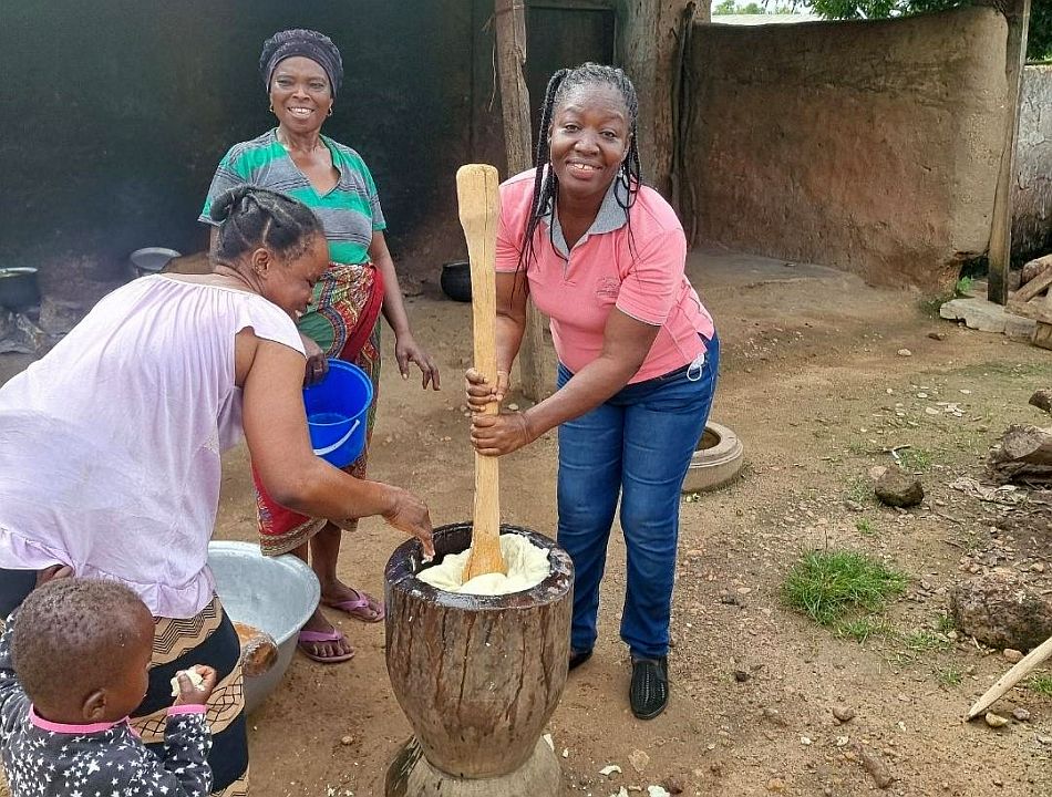 Charity participating in early morning yam fufu pounding at Poyentanga Community, Wa West District of the Upper West Region of Ghana.