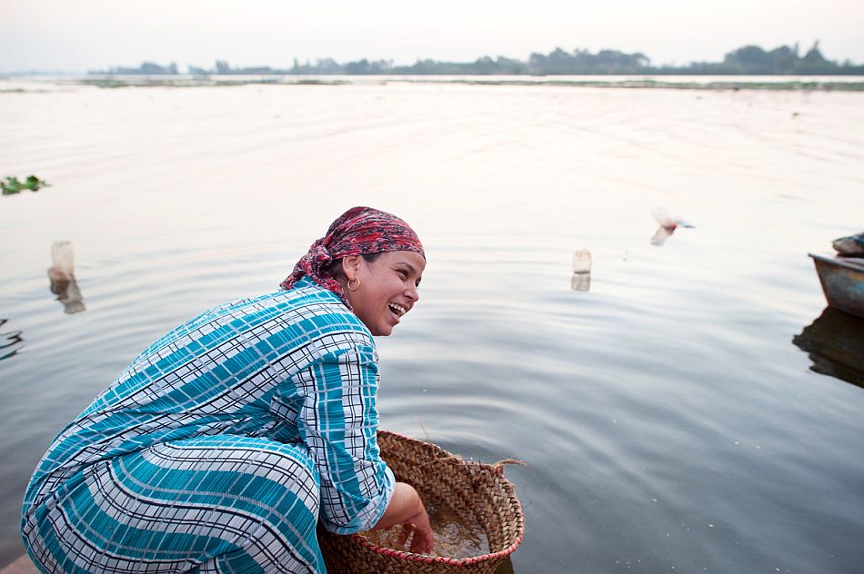 Woman washing wheat in a river in Egypt. Photo: Hamish John Appleby