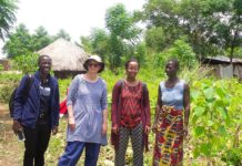 Dr. Gebrezgabher (third from left) and research partners meet with a Ugandan refugee woman in the Rhino Refugee Settlement. Photo: IWMI
