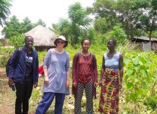 Dr. Gebrezgabher (third from left) and research partners meet with a Ugandan refugee woman in the Rhino Refugee Settlement. Photo: IWMI