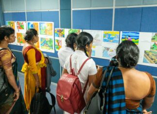 School children and teachers from the Nuwara Eliya district look at the art competition entries.